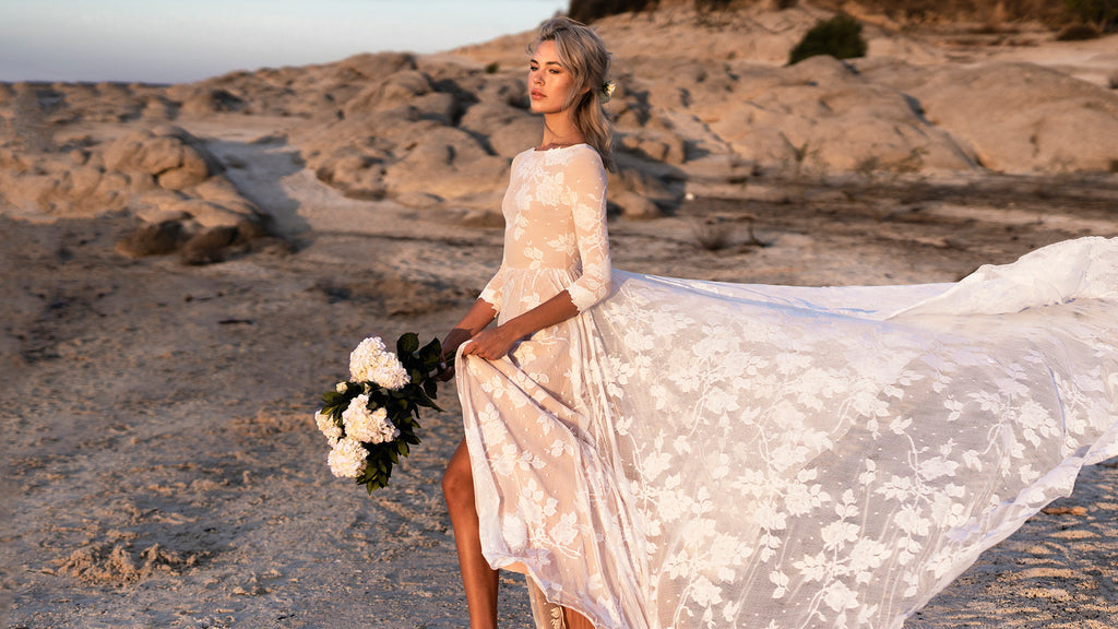 bride eloping at the beach in lace dress with skirt slit