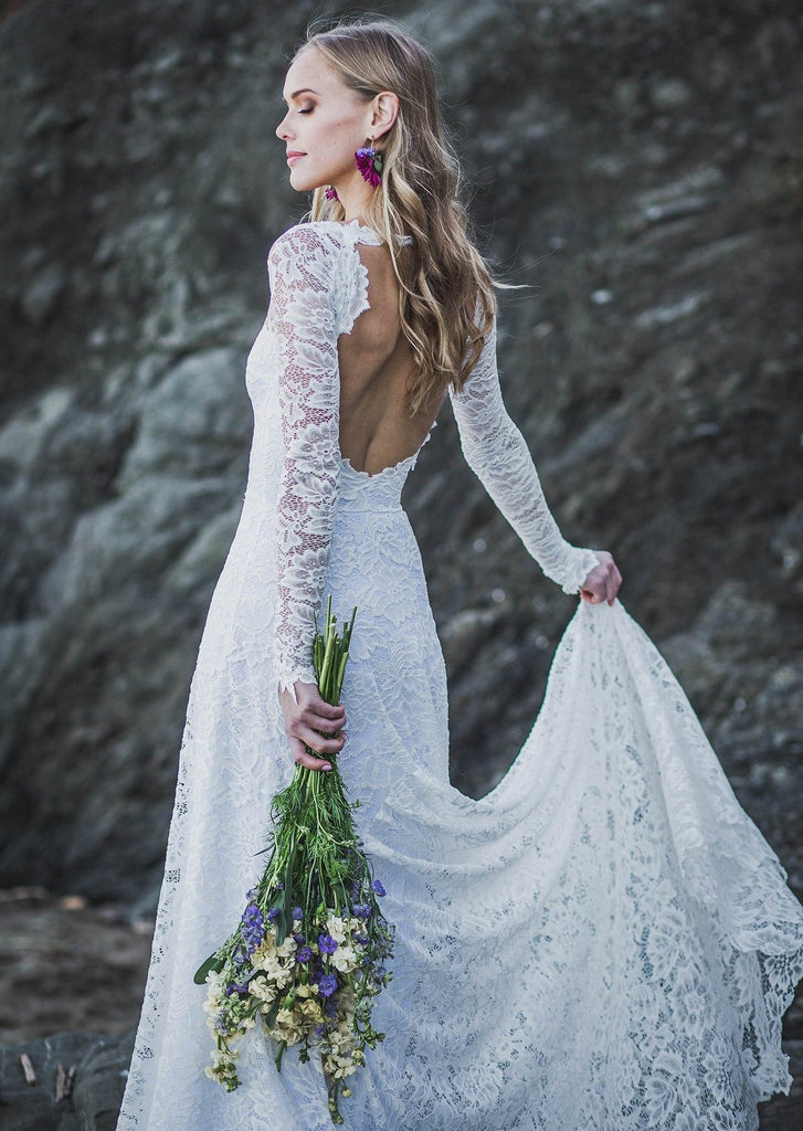 Bride wearing Indigo Dress holding bouquet in front of rock formation