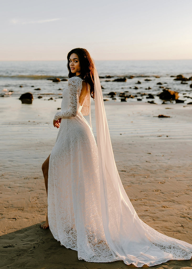 Bride wearing Shay veil and Cascade dress on beach