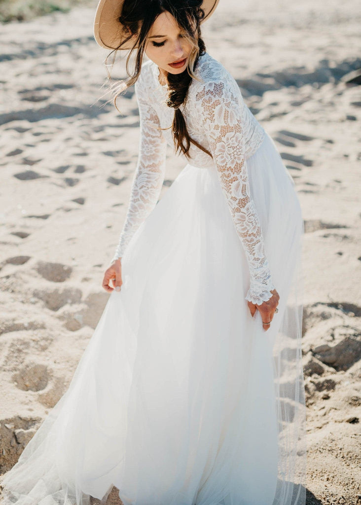 Bride in hat on beach wearing Zoey 2.0 boho wedding dress