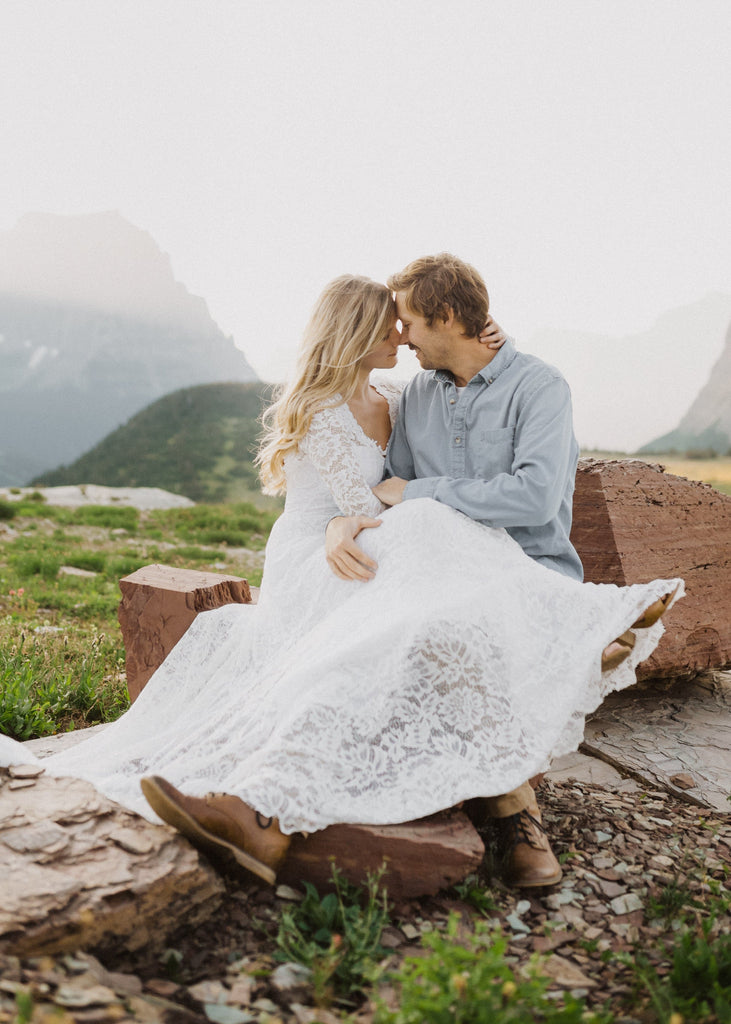 Bride in Indigo Dress having intimate moment with groom in Glacier National Park