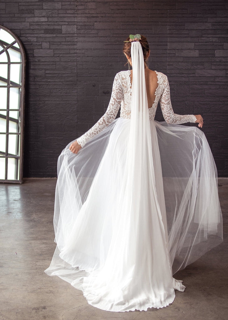 Bride indoors wearing Kenna veil and Zoey Scoop Back dress, from behind
